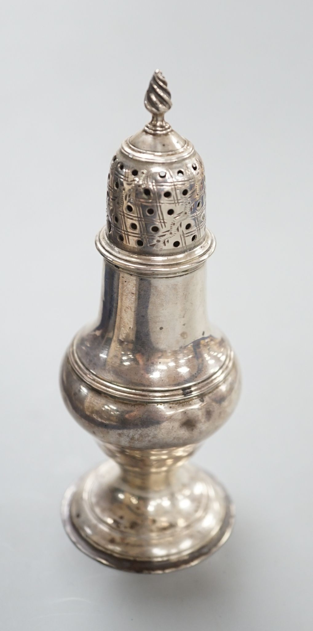 A George III silver baluster pepperette, Thomas Daniell, London, 1783, 13.2cm, 74 grams.